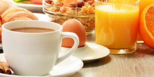 Breakfast with coffee, orange juice, croissant, egg, vegetables and fruits Breakfast with coffee, orange juice, croissant, egg, vegetables and fruits