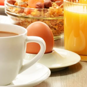 Breakfast with coffee, orange juice, croissant, egg, vegetables and fruits Breakfast with coffee, orange juice, croissant, egg, vegetables and fruits
