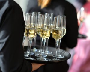 Waitress holding a dish of champagne and wine glasses Waitress holding a dish of champagne and wine glasses